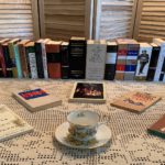 Books on display with a teacup (all on a table).