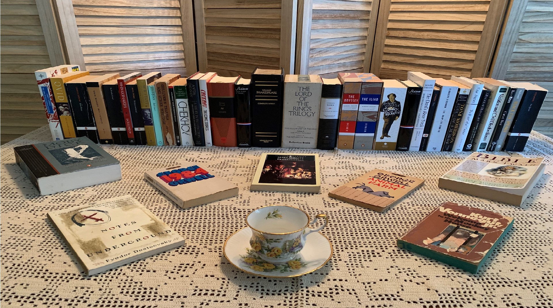 Books on display with a teacup (all on a table).