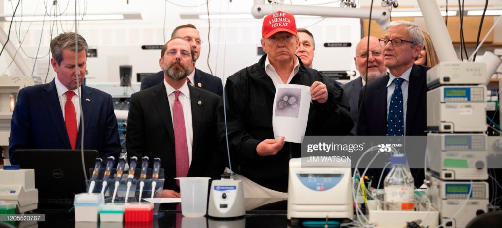 FOREGROUND (FROM LEFT TO RIGHT):
BRIAN PORTER KEMP, ALEX MICHAEL AZAR II, DONALD JOHN TRUMP, AND STEVE MONROE.
BACKGROUND (FROM LEFT TO RIGHT):
DOUGLAS ALLEN COLLINS, DAVID ALFRED PERDUE, JR., ROBERT RAY REDFIELD, JR., AND KELLY LYNN LOEFFLER.
AT THE CENTERS FOR DISEASE CONTROL AND PREVENTION,
IN ATLANTA, GEORGIA, ON FRIDAY, 6 MARCH 2020.
(PHOTO BY JIM WATSON/AFP VIA GETTY IMAGES.)